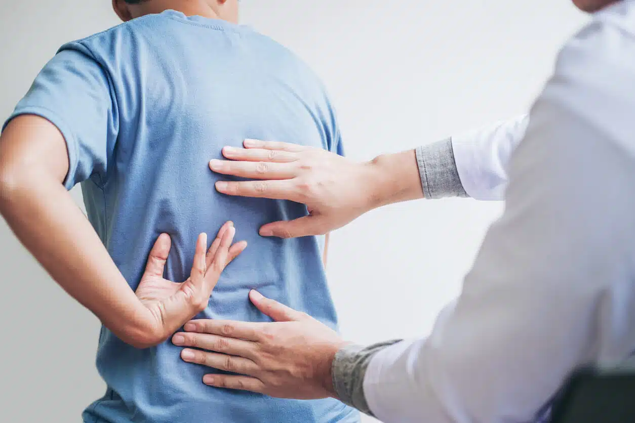 3 Clinical practitioner conducting a non-surgical spine check and manual Marma assessment