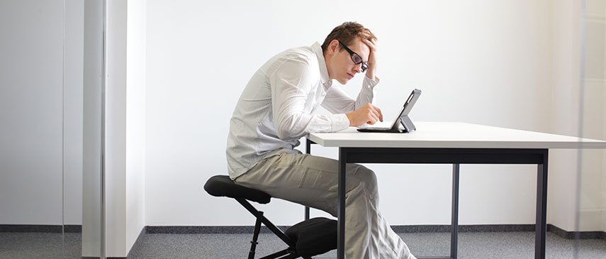 2 Slouched sitting posture causing mechanical stress and compressed discs in the lower back